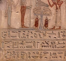 Hieroglyphic carvings on the exterior walls of an ancient egyptian temple