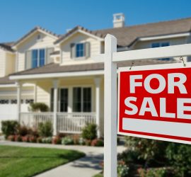 Home For Sale Real Estate Sign in Front of New House.