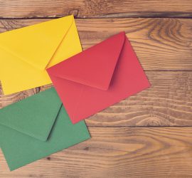 Colored Envelopes On Wooden Table. Concept Holidays, Communicati